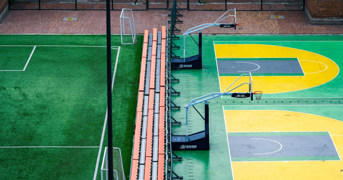 Outdoor basketball and soccer courts with bleachers.