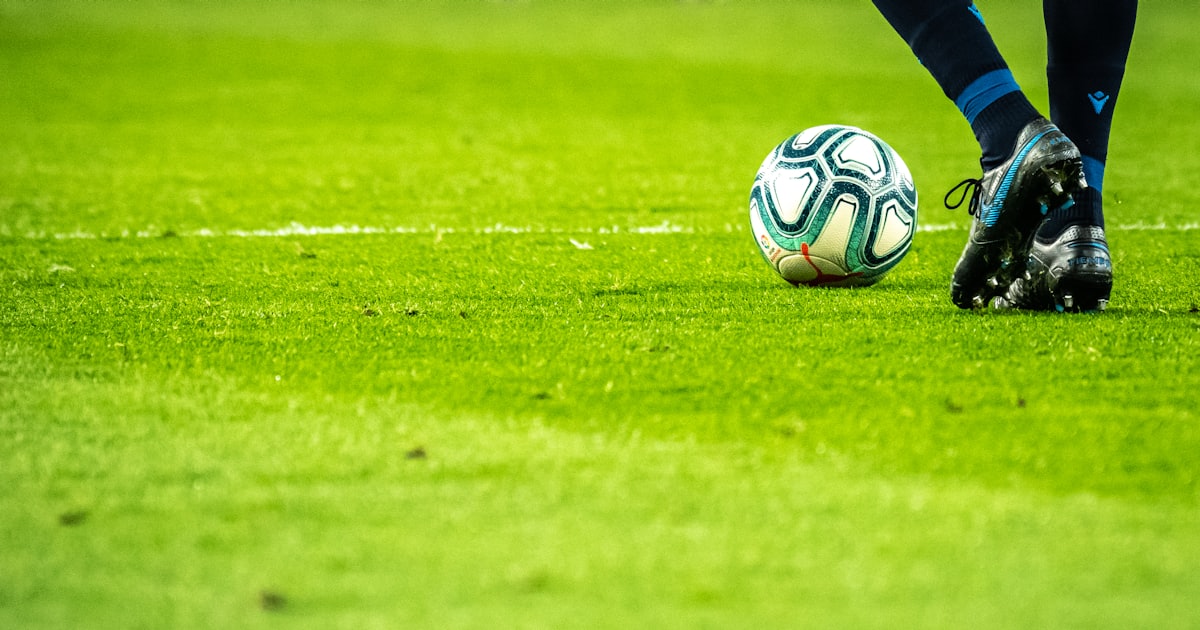 man playing soccer game on field