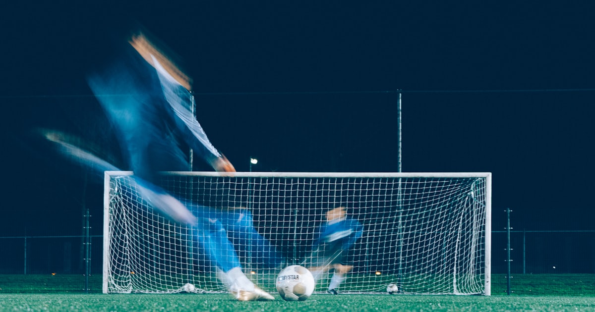 timelapse photo of soccer player kicking ball