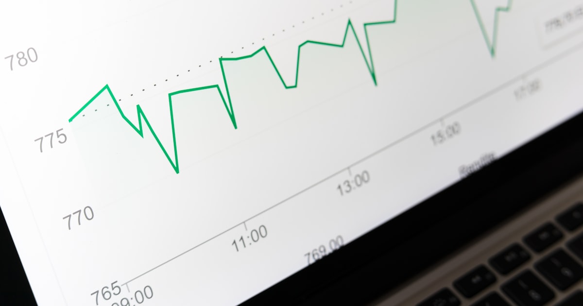 stock market chart displayed on laptop screen