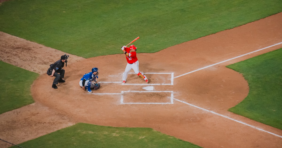 Baseball batter at home plate with catcher and umpire.