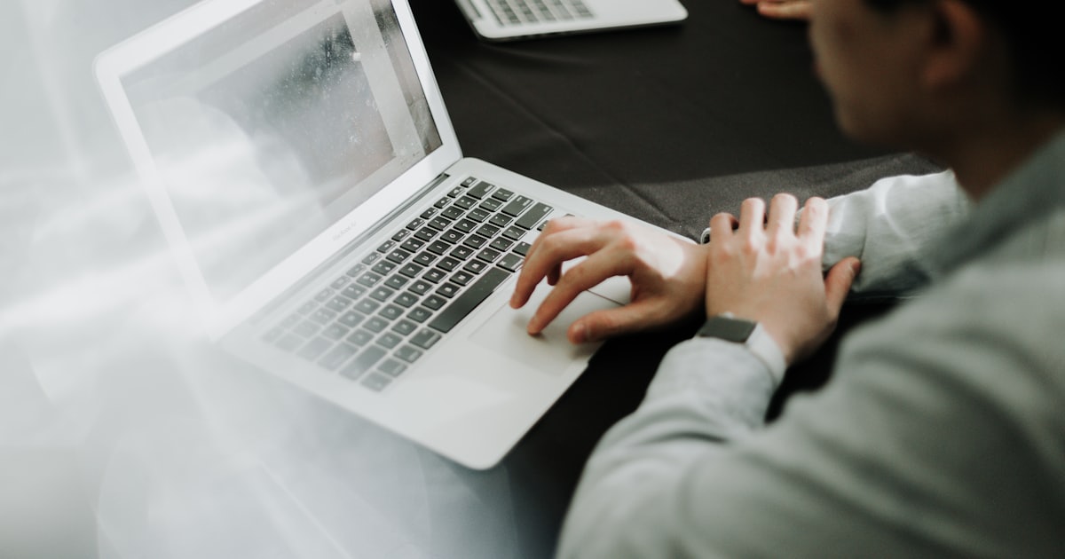 a man sitting in front of a laptop computer