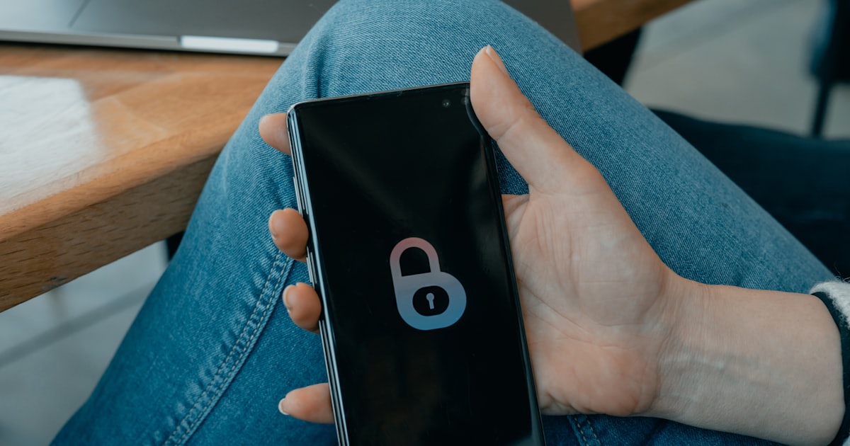 black and white smartphone on persons hand