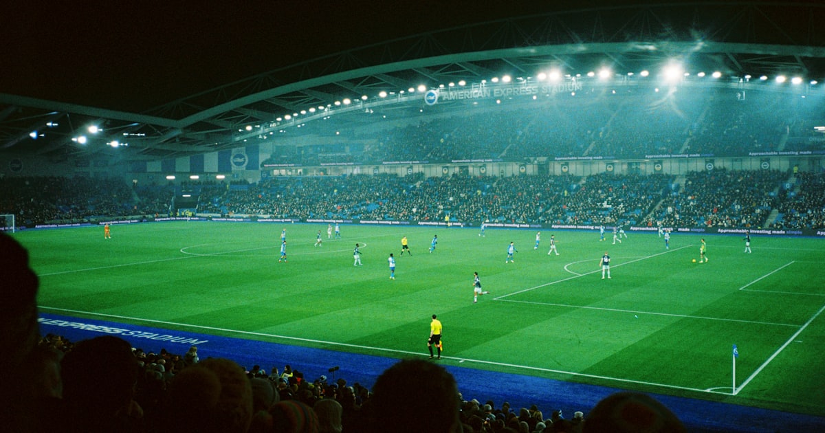 a soccer match in a stadium at night